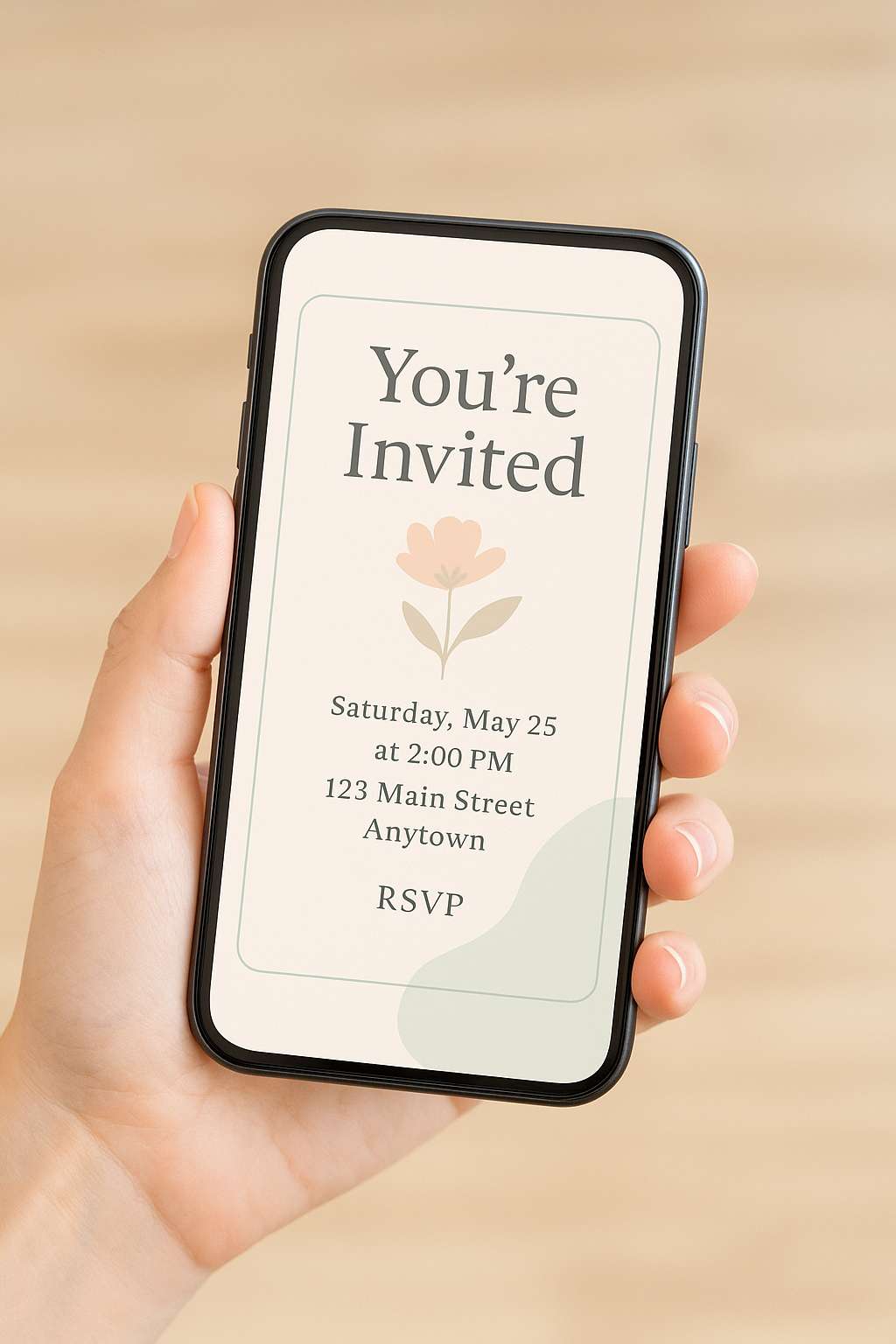 Hand holding smartphone displaying digital invitation with floral design and event details, promoting eco-friendly online invites.